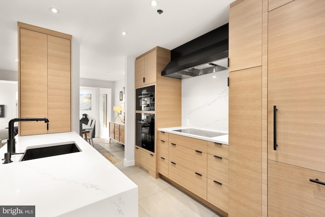 kitchen featuring sink, wall chimney range hood, black appliances, light tile patterned flooring, and light brown cabinets