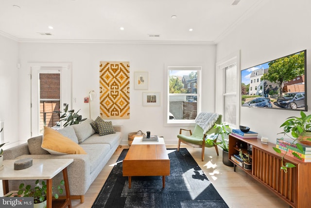 living room featuring light hardwood / wood-style flooring and ornamental molding