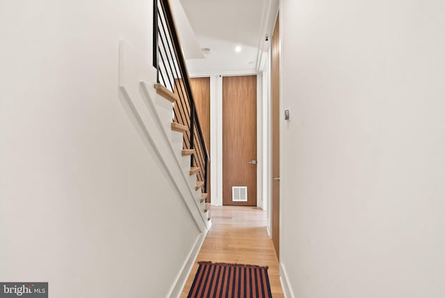 corridor with light hardwood / wood-style flooring