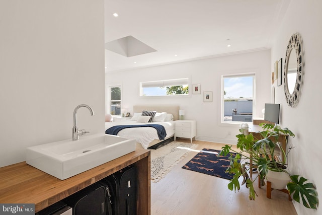 bedroom featuring sink and hardwood / wood-style floors