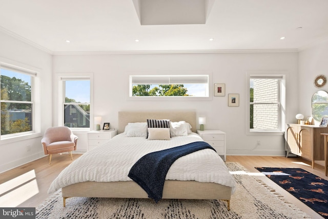 bedroom featuring light wood-type flooring and ornamental molding