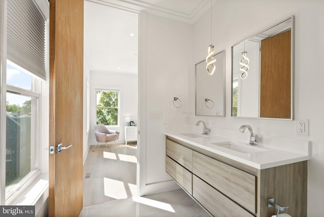 bathroom with ornamental molding and vanity