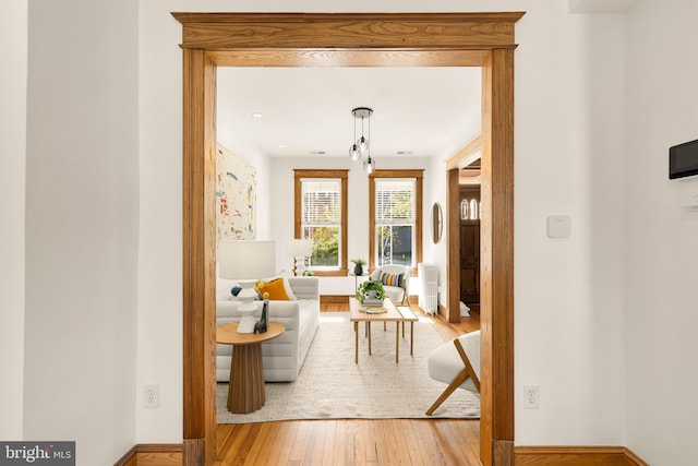 hallway featuring hardwood / wood-style flooring and radiator heating unit