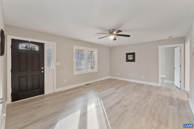 foyer entrance with light hardwood / wood-style floors and ceiling fan