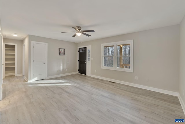 unfurnished room with light hardwood / wood-style flooring and ceiling fan