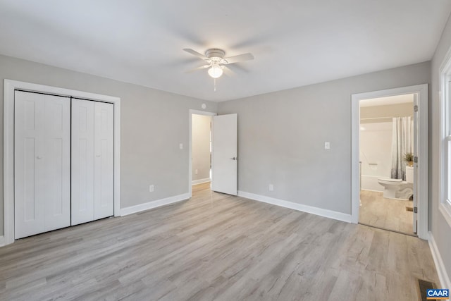 unfurnished bedroom with ceiling fan, light hardwood / wood-style floors, ensuite bathroom, and a closet