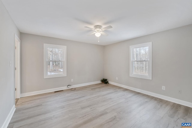 spare room featuring light hardwood / wood-style floors, plenty of natural light, and ceiling fan