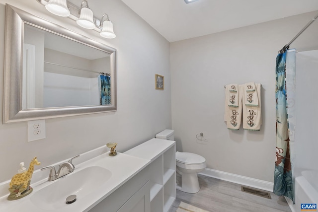 bathroom with vanity, hardwood / wood-style flooring, and toilet