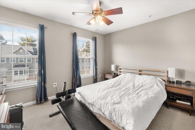 bedroom with ceiling fan and light carpet