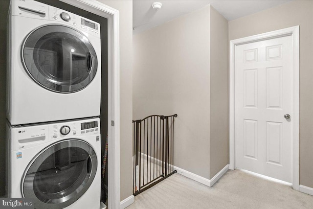 washroom with light colored carpet and stacked washing maching and dryer