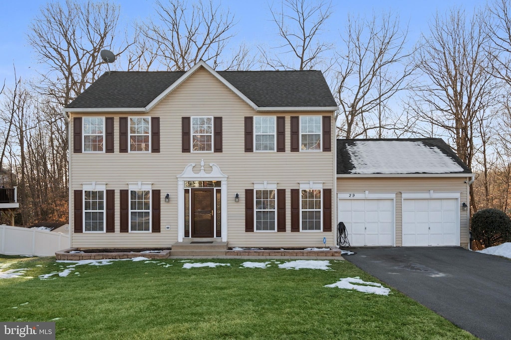 colonial house with a garage and a front yard