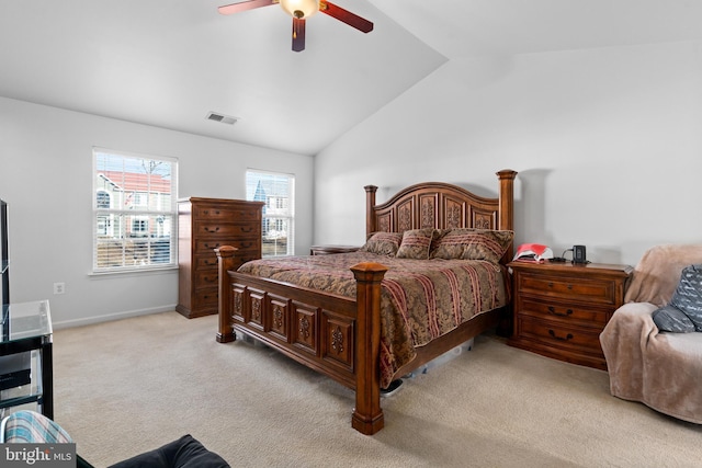 bedroom featuring ceiling fan, light colored carpet, and vaulted ceiling