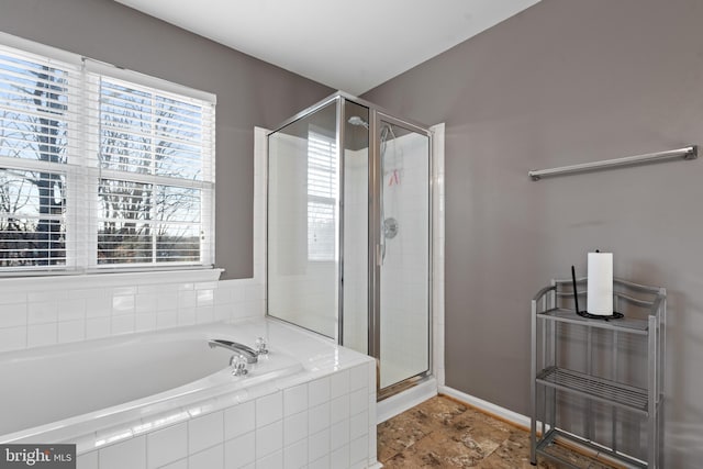 bathroom featuring separate shower and tub