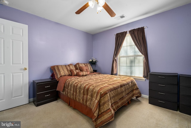 bedroom featuring light carpet and ceiling fan