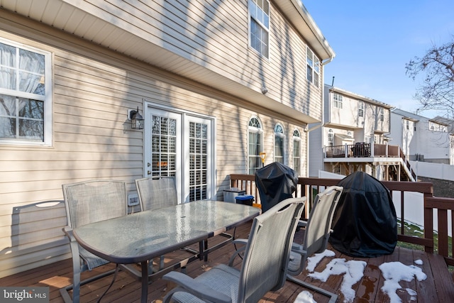 wooden deck featuring a grill