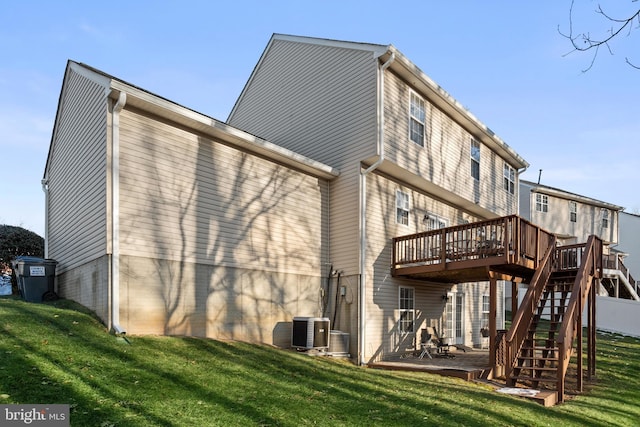 back of house featuring a patio, a deck, central AC unit, and a lawn