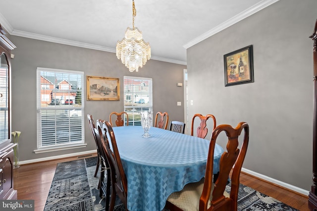 dining room with crown molding, dark hardwood / wood-style floors, and a chandelier