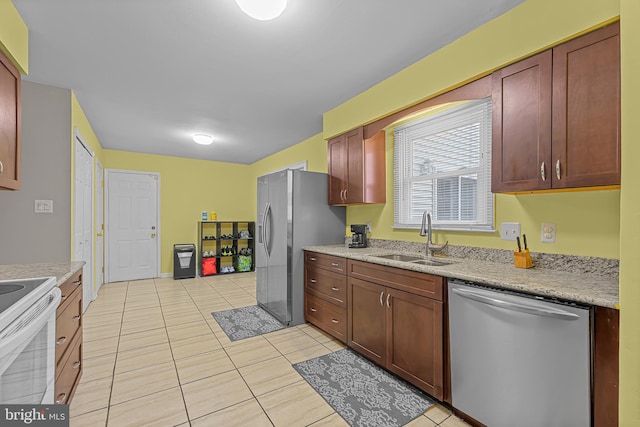 kitchen featuring sink, light tile patterned floors, and stainless steel appliances