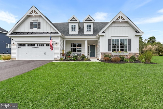 view of front of house featuring a garage, covered porch, and a front lawn