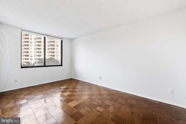 empty room featuring a textured ceiling