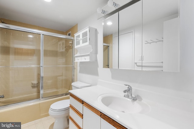 full bathroom featuring vanity, toilet, and combined bath / shower with glass door