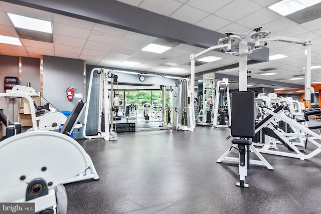 exercise room featuring a drop ceiling