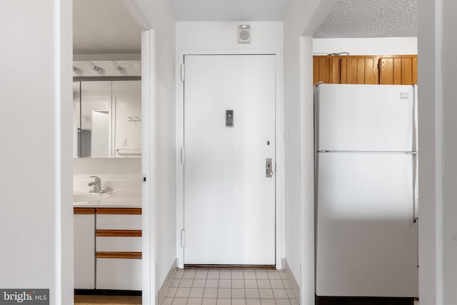 interior space featuring sink and a textured ceiling