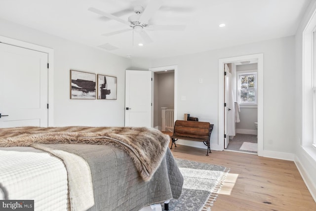 bedroom featuring connected bathroom, ceiling fan, and light wood-type flooring