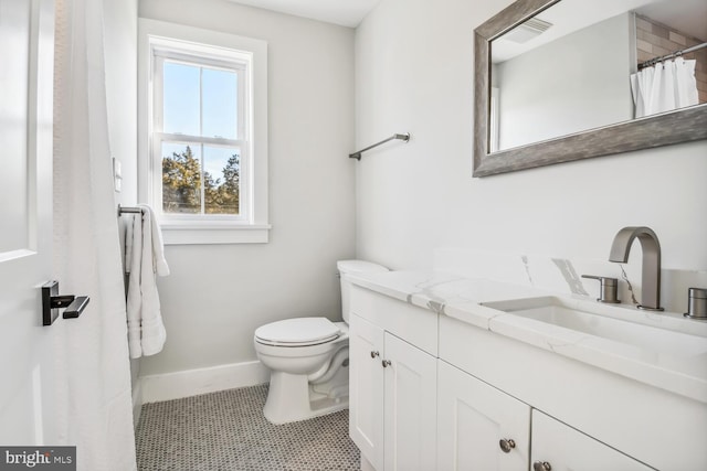 bathroom featuring vanity, curtained shower, tile patterned floors, and toilet