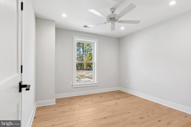 spare room with ceiling fan and light wood-type flooring