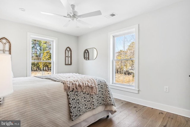 bedroom with hardwood / wood-style floors and ceiling fan