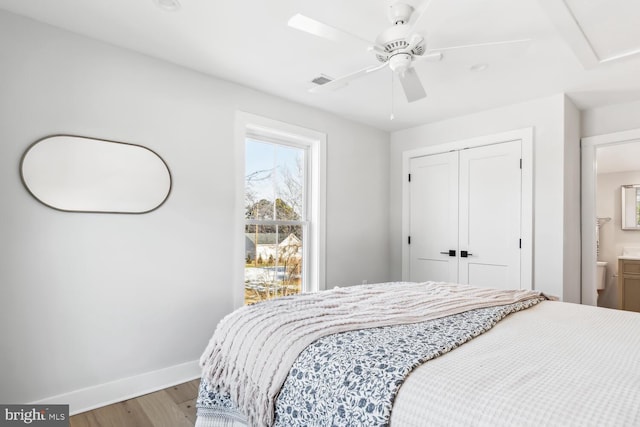 bedroom featuring hardwood / wood-style flooring, a closet, and ceiling fan