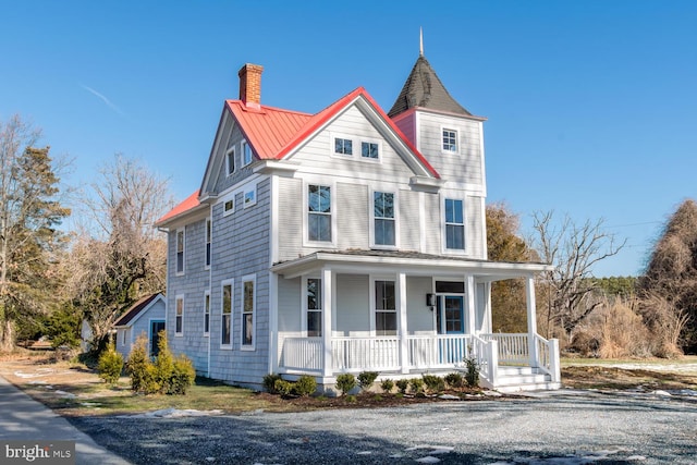 victorian-style house featuring a porch