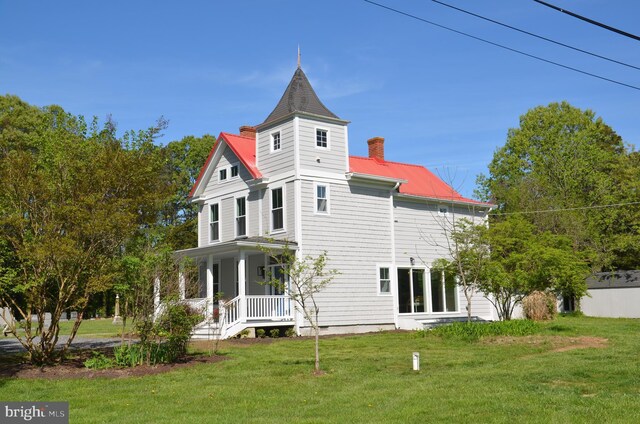8013 Ruby Harrison Rd, Bozman, MD 21612 - back of property featuring a porch, a lawn, a chimney, and metal roof