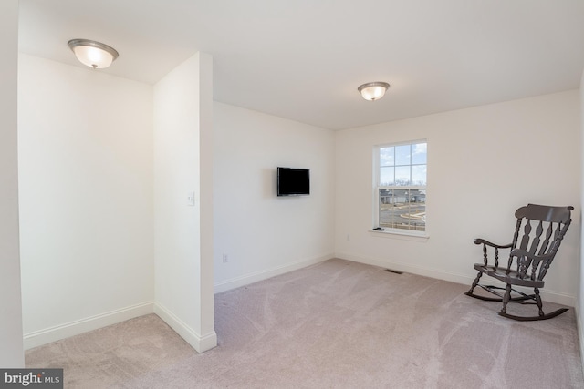 unfurnished room with light carpet