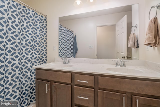 bathroom featuring vanity and curtained shower