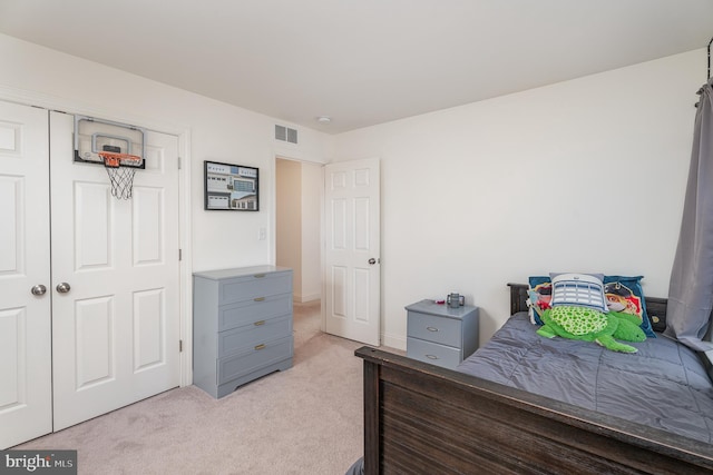 carpeted bedroom featuring a closet