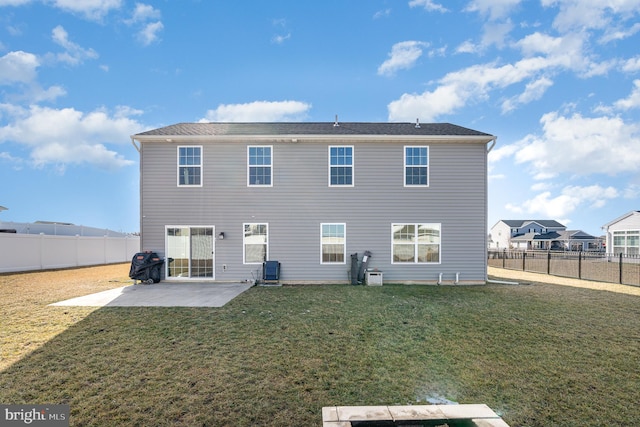 rear view of property with a yard and a patio area