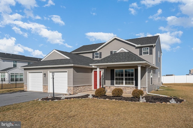 view of front property featuring a garage and a front lawn