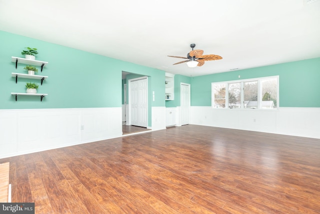 unfurnished room with dark hardwood / wood-style flooring and ceiling fan