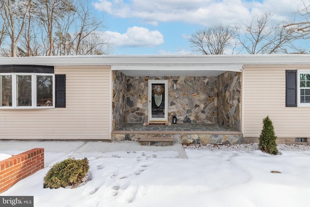 view of snow covered property entrance