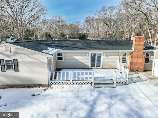 snow covered property featuring a wooden deck