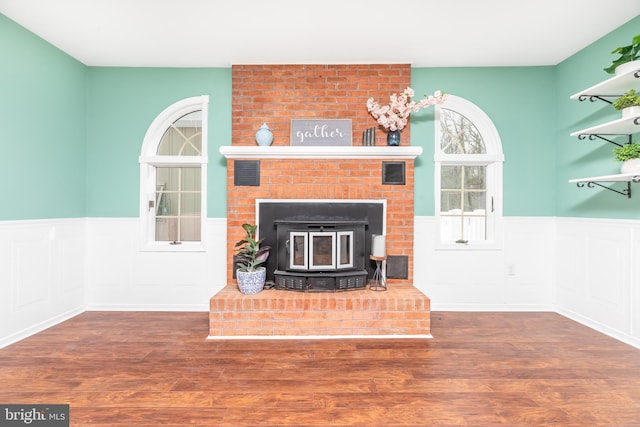 living room featuring dark hardwood / wood-style flooring and a wood stove