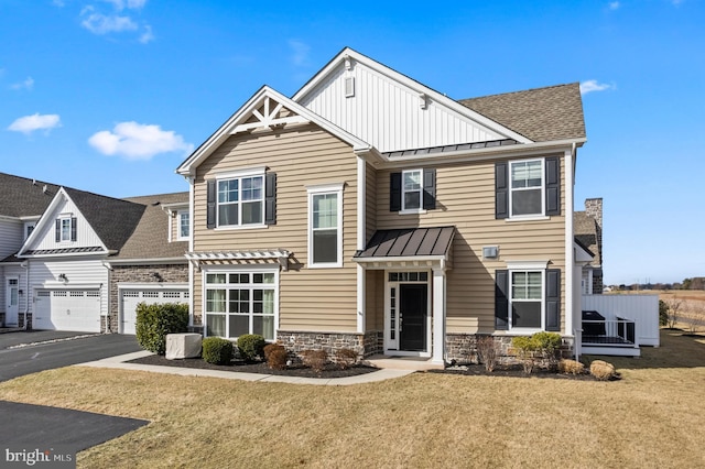 view of front of property featuring central AC, a garage, and a front yard