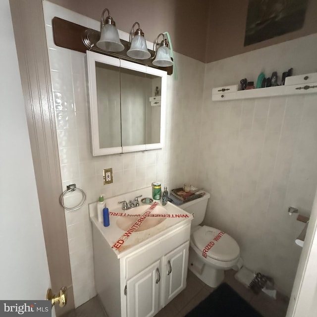 half bath featuring backsplash, tile walls, toilet, and vanity