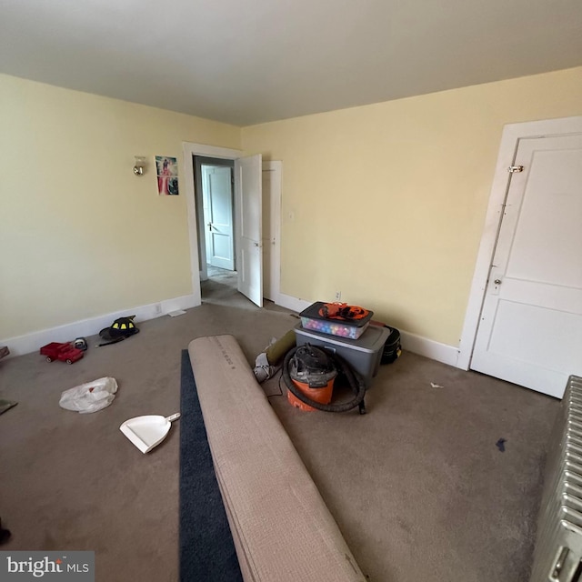 interior space with baseboards and carpet flooring