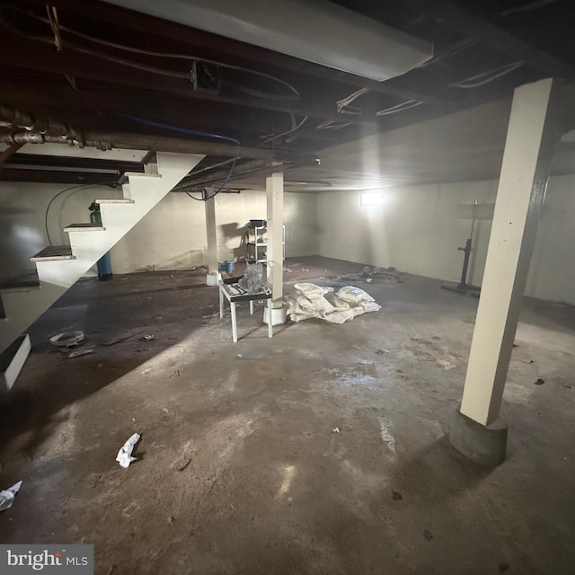 unfinished basement featuring stairs