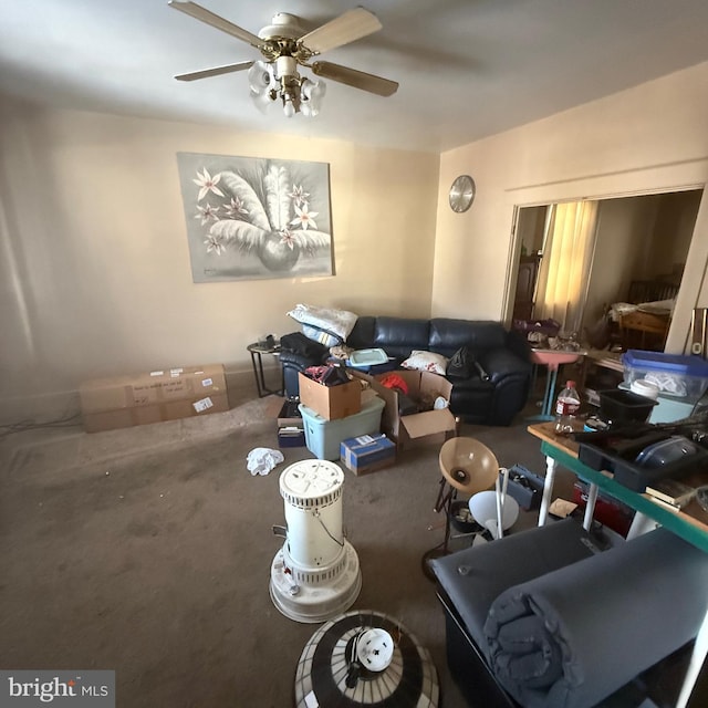 carpeted living area featuring ceiling fan