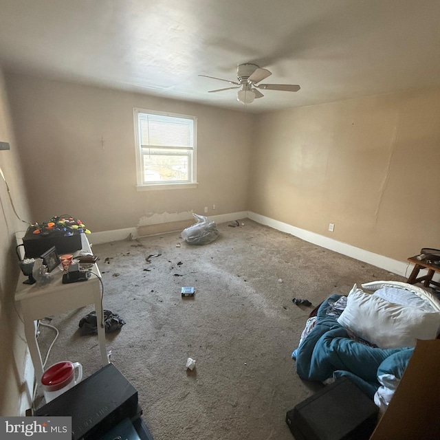 interior space featuring ceiling fan and baseboards