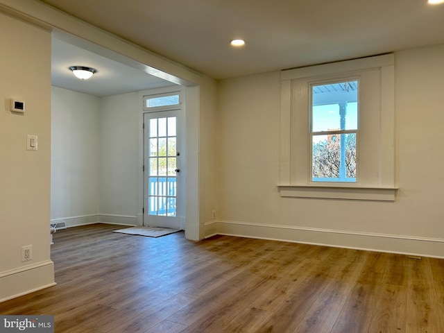 spare room with wood-type flooring